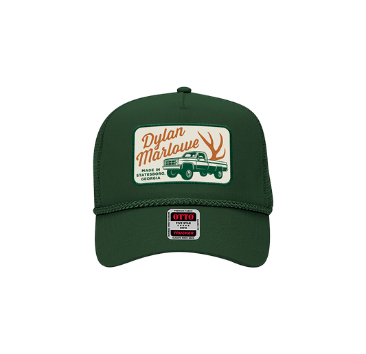 A dark green Patch Hat with rope detail and a snapback closure. Features a front logo with the text 'Dylan Marlowe' and a graphic of a truck.