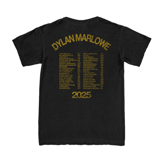 Black t-shirt with yellow text of Dy;an's 2025 tour cities on the back