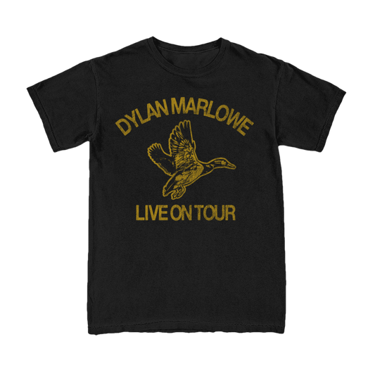 A black short-sleeve crewneck t-shirt featuring a gold graphic print of a flying duck with the text 'DYLAN MARLOWE' above and 'LIVE ON TOUR' below.